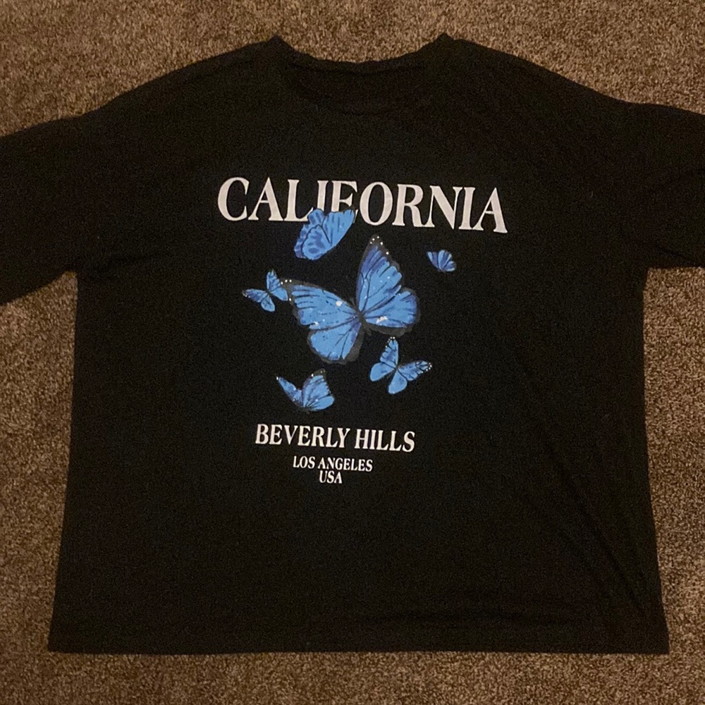 Black over sized T-shirt with blue butterfly’s from SHIEN.